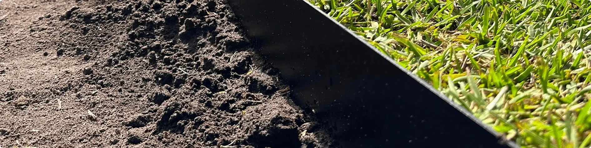 black powder-coated steel garden edging around lawn bed