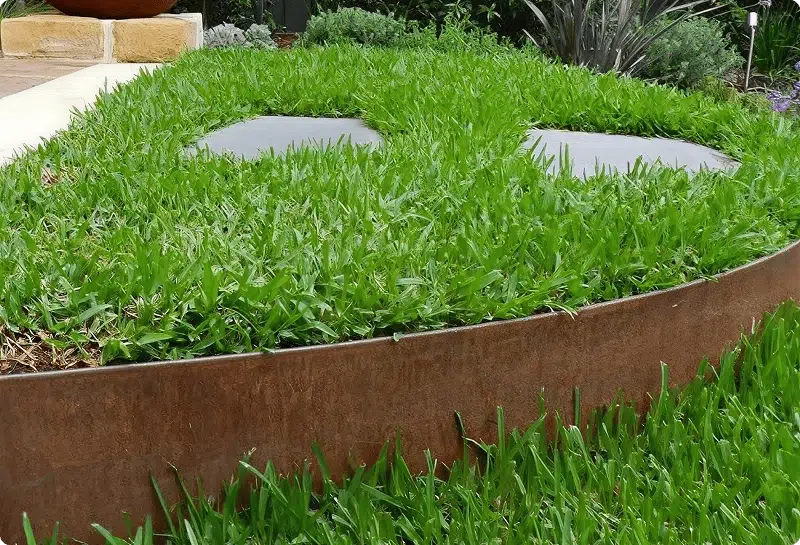 Corten garden edging around a curved lawn and garden path