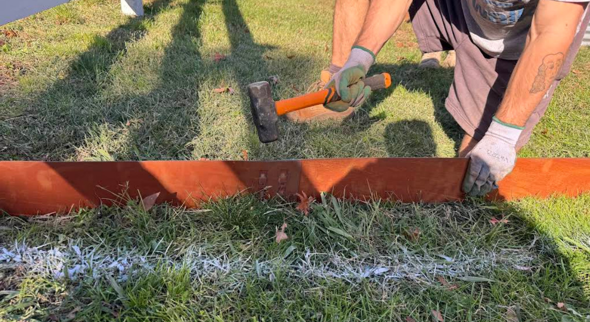 Installing corten steel garden edging with a mallet