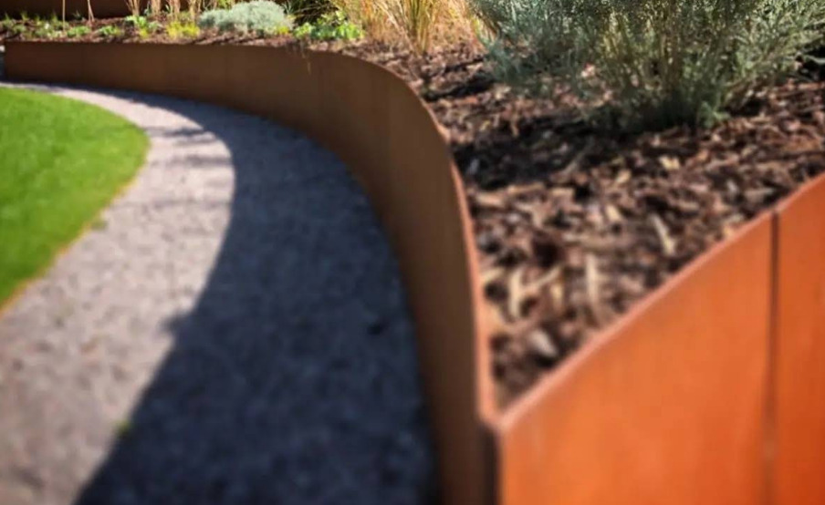 Curved corten steel garden edging creating a finished landscape border